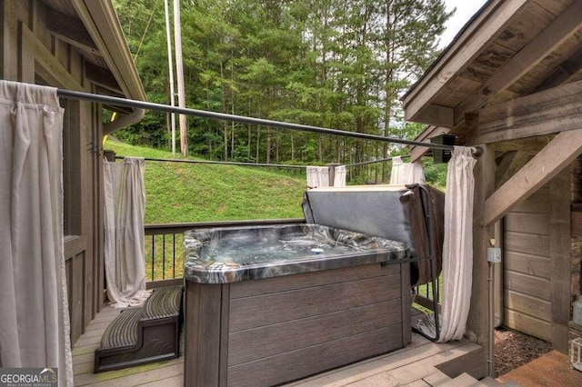 wooden deck featuring a hot tub