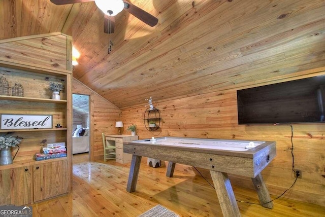 playroom featuring vaulted ceiling, ceiling fan, wooden walls, and light hardwood / wood-style floors