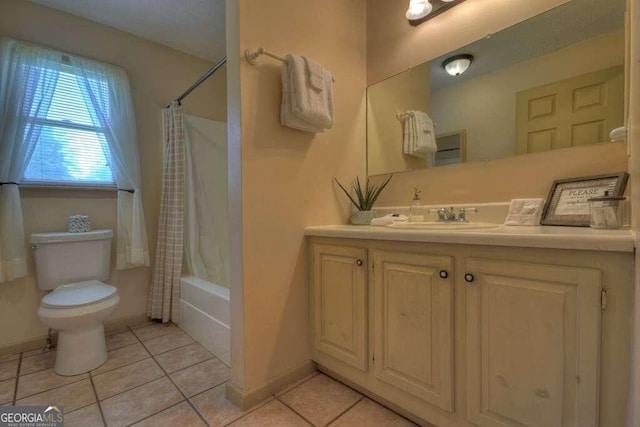 full bathroom with vanity, toilet, shower / bath combo with shower curtain, and tile patterned flooring