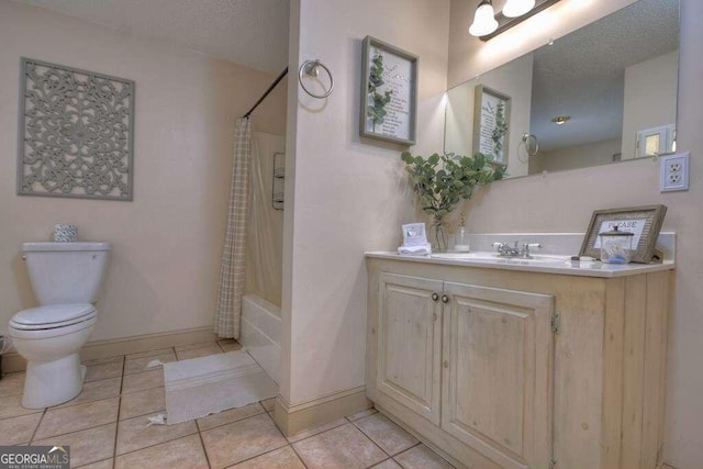 full bathroom featuring tile patterned floors, toilet, shower / bath combination with curtain, vanity, and a textured ceiling