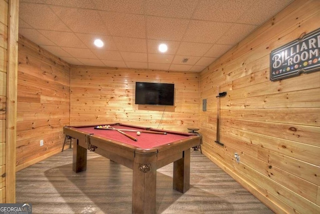 playroom with wood-type flooring, a paneled ceiling, wood walls, and pool table