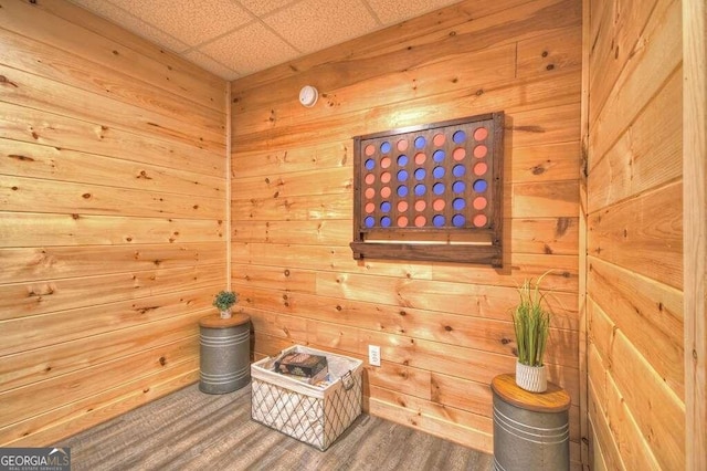 living area featuring a paneled ceiling and hardwood / wood-style floors