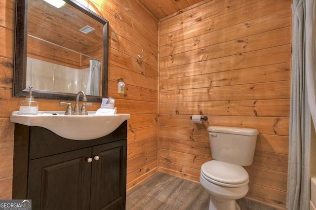 bathroom featuring vanity, wood walls, curtained shower, wood ceiling, and toilet