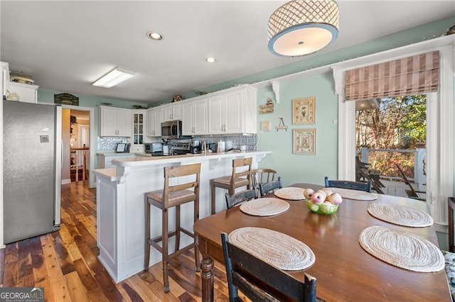 dining space with recessed lighting and wood finished floors