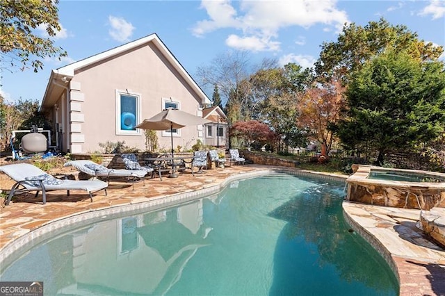 view of swimming pool with an in ground hot tub and a patio