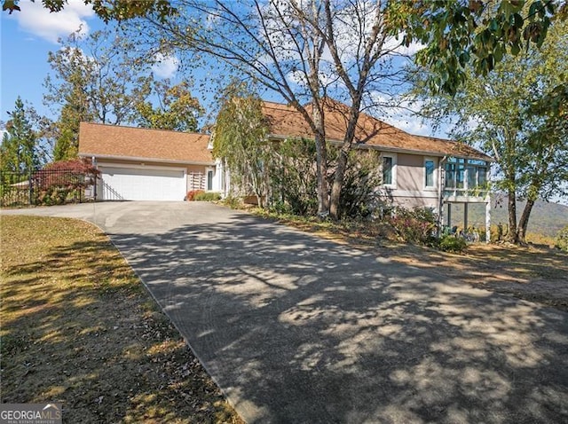 view of front of house with concrete driveway, a garage, and stucco siding