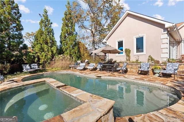 view of swimming pool with a fenced in pool, an in ground hot tub, and a patio area