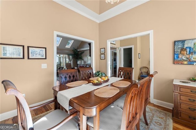 dining space with wood-type flooring and crown molding