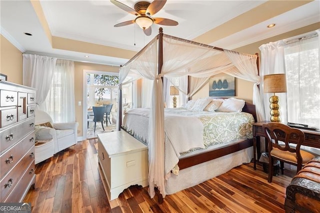 bedroom featuring access to exterior, hardwood / wood-style floors, crown molding, a raised ceiling, and ceiling fan