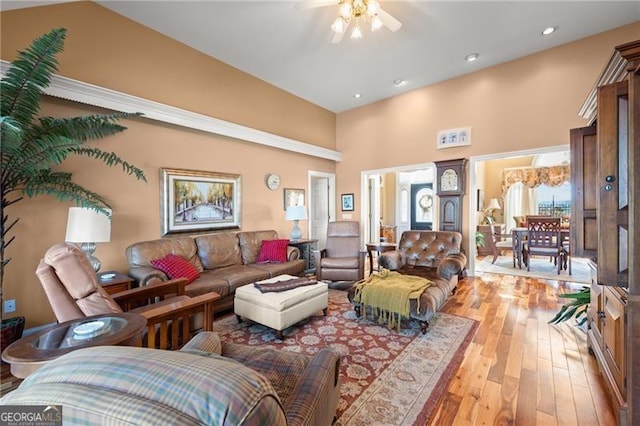 living room featuring high vaulted ceiling and hardwood / wood-style flooring