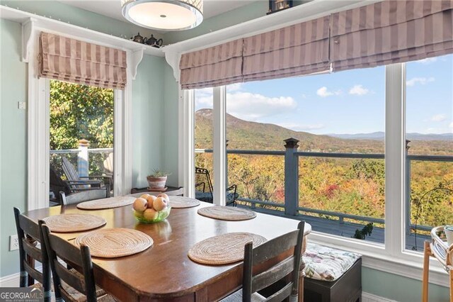 dining area featuring a mountain view and a wealth of natural light