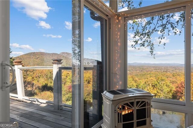 sunroom / solarium featuring a mountain view