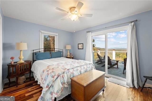 bedroom with access to exterior, ceiling fan, and wood-type flooring