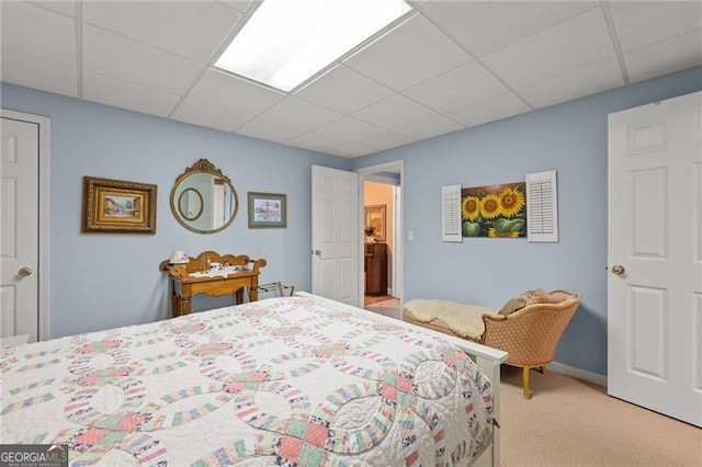 bedroom featuring a paneled ceiling and carpet floors