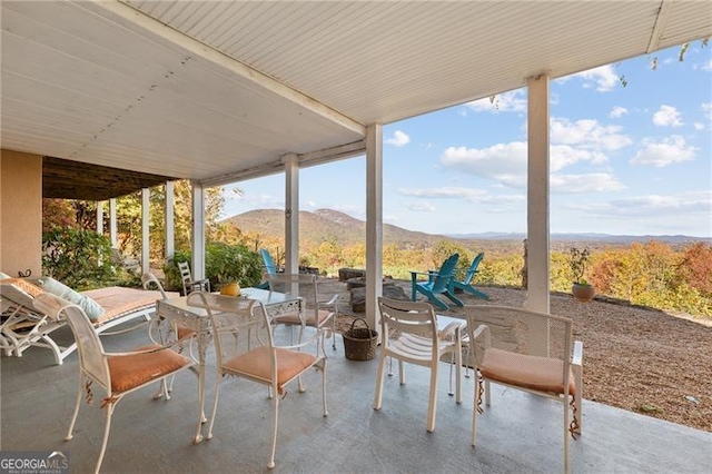 view of patio featuring outdoor dining area and a mountain view