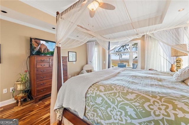 bedroom featuring crown molding, hardwood / wood-style flooring, and ceiling fan