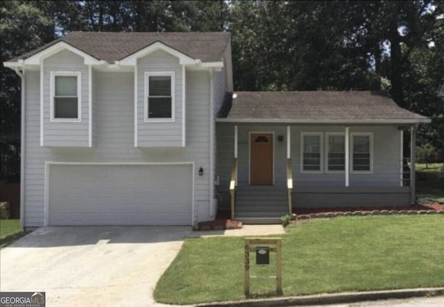 tri-level home with a garage and a front yard