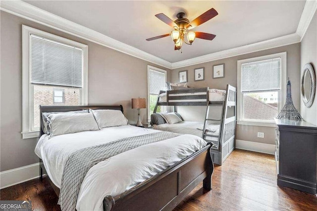 bedroom featuring crown molding, ceiling fan, and hardwood / wood-style flooring