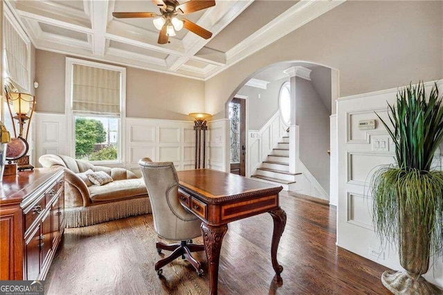 dining area with beamed ceiling, coffered ceiling, ornamental molding, ceiling fan, and dark hardwood / wood-style floors