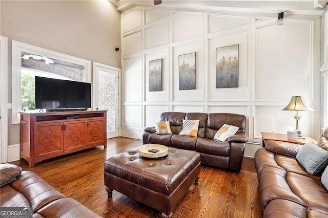 living room featuring dark hardwood / wood-style flooring and vaulted ceiling