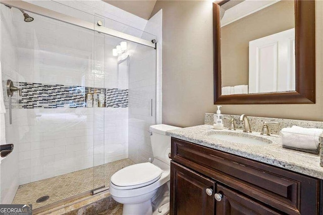 bathroom with vanity, toilet, and walk in shower