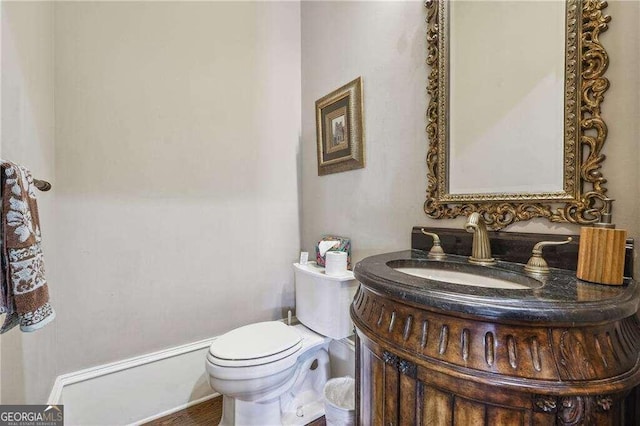 bathroom featuring toilet and vanity