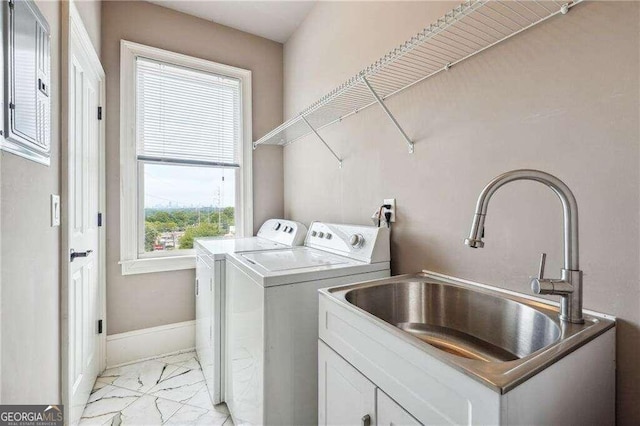 washroom featuring sink, cabinets, and washer and dryer