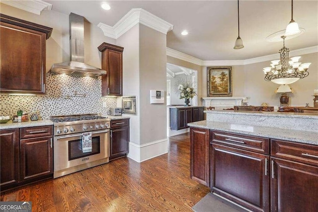 kitchen with dark hardwood / wood-style floors, wall chimney exhaust hood, a notable chandelier, ornamental molding, and high end stove