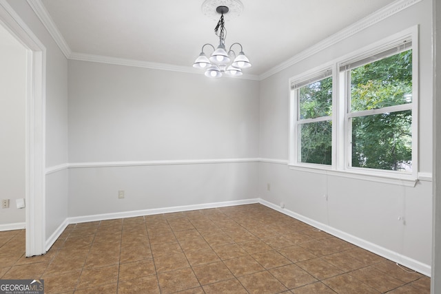 empty room featuring dark tile patterned flooring, crown molding, and a notable chandelier