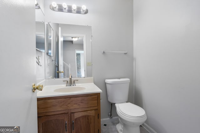 bathroom with tile patterned floors, vanity, and toilet