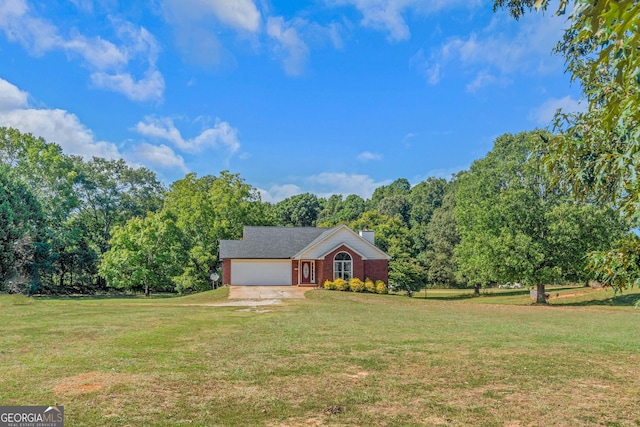 ranch-style house featuring a front yard, a chimney, an attached garage, and driveway