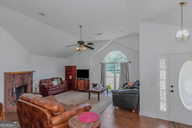 living room with high vaulted ceiling, hardwood / wood-style floors, ceiling fan, and a fireplace