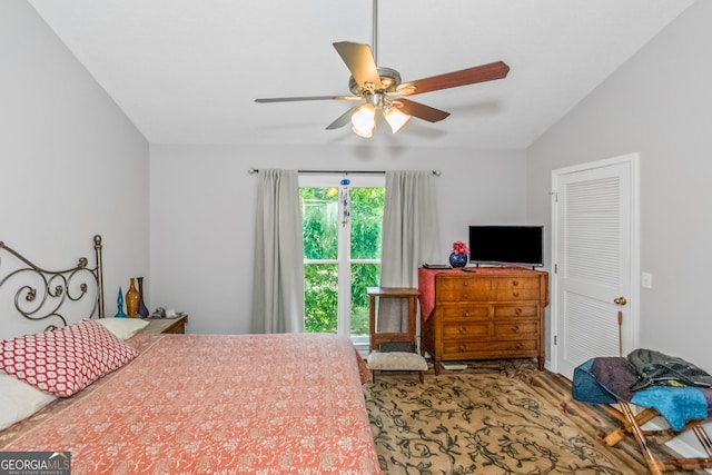 bedroom featuring lofted ceiling, wood finished floors, and a ceiling fan