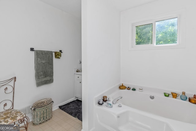 full bathroom with a garden tub and vanity