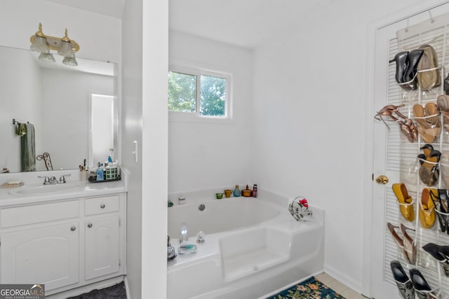 bathroom featuring a bath, vanity, and tile patterned flooring