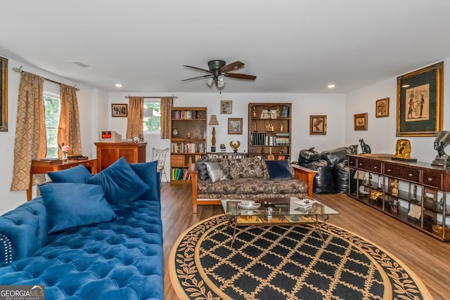 living area featuring wood finished floors, a ceiling fan, and recessed lighting