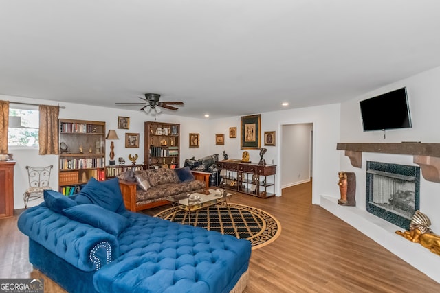 living room featuring hardwood / wood-style floors and ceiling fan