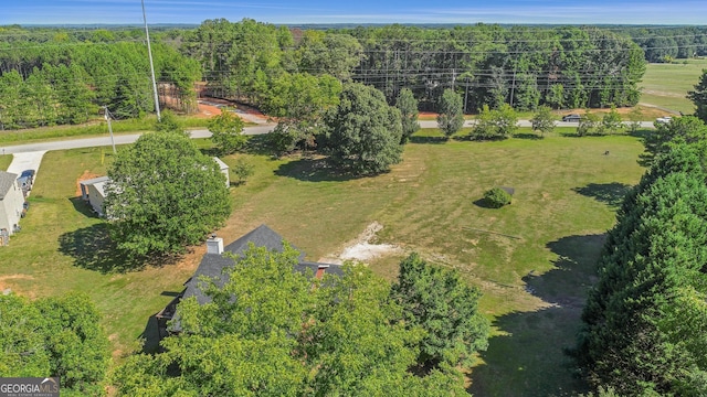 view of property location with a forest
