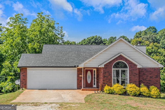 view of front facade with a front yard and a garage