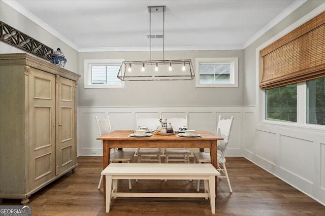 dining room with ornamental molding and dark hardwood / wood-style flooring