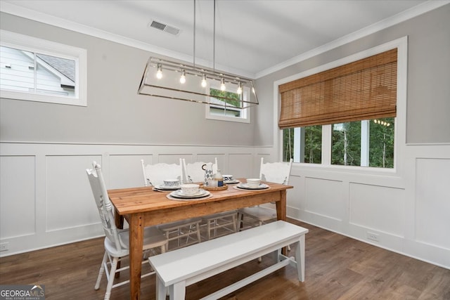 dining room with dark hardwood / wood-style flooring and ornamental molding