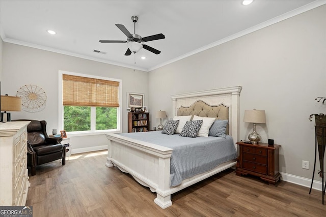 bedroom with crown molding, ceiling fan, and dark hardwood / wood-style flooring