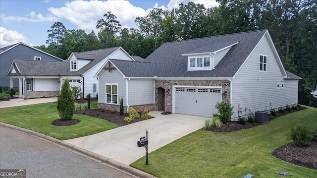 view of front of house featuring cooling unit, a front yard, and a garage