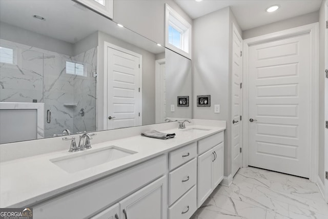 bathroom with vanity and a shower with shower door