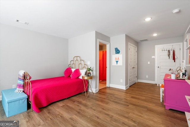 bedroom with hardwood / wood-style flooring