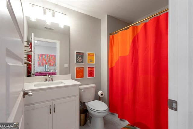 bathroom featuring vanity and toilet