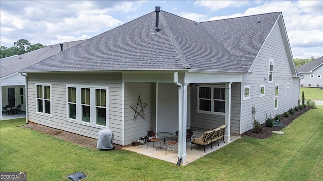 rear view of house with a yard and a patio area