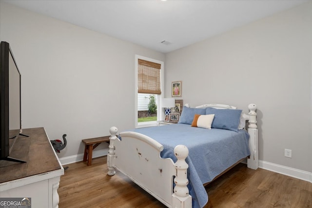 bedroom with hardwood / wood-style flooring