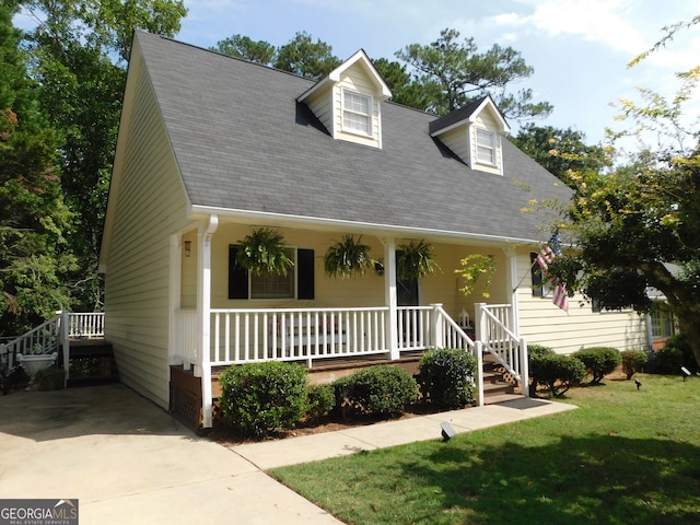 cape cod-style house featuring a front yard and a porch