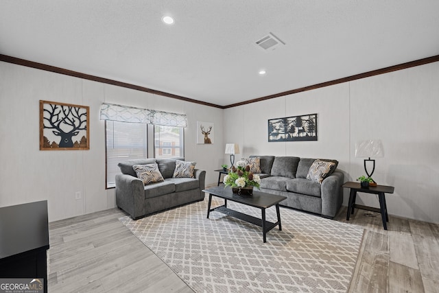 living room with crown molding, a textured ceiling, and light hardwood / wood-style flooring